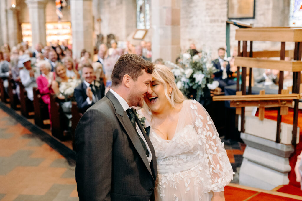 natural photos of bride and groom during church ceremony