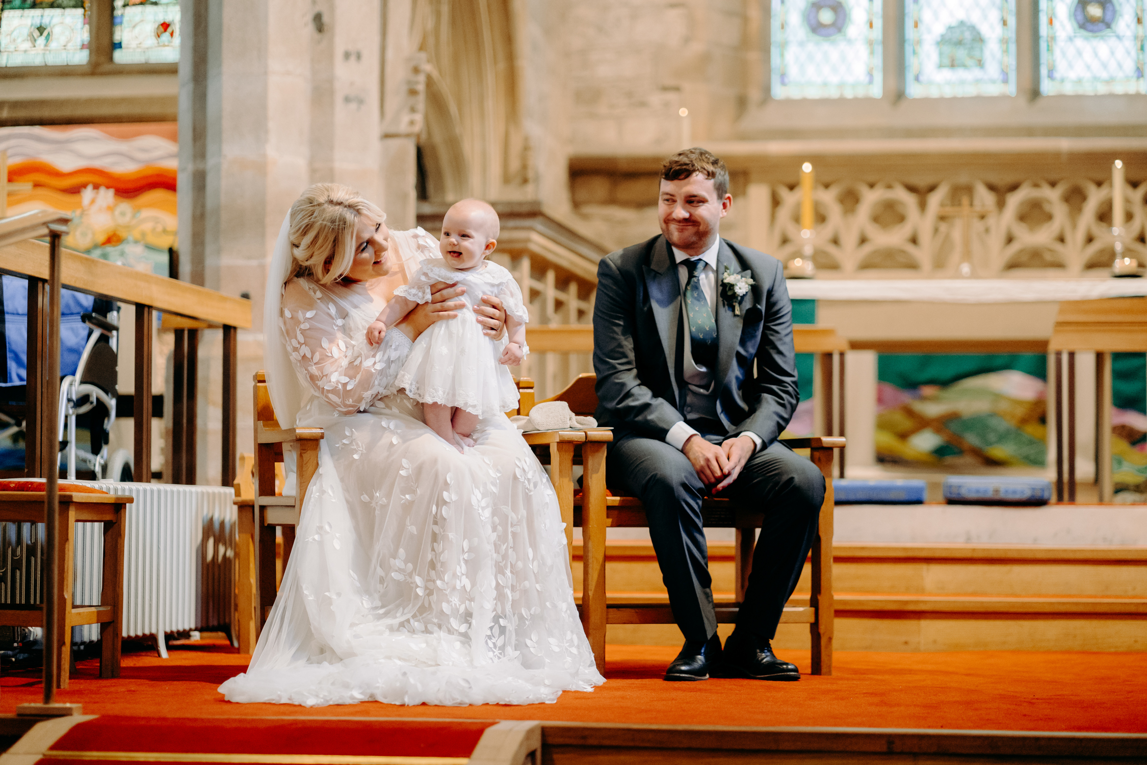 bride, groom and their flower girl during church ceremony