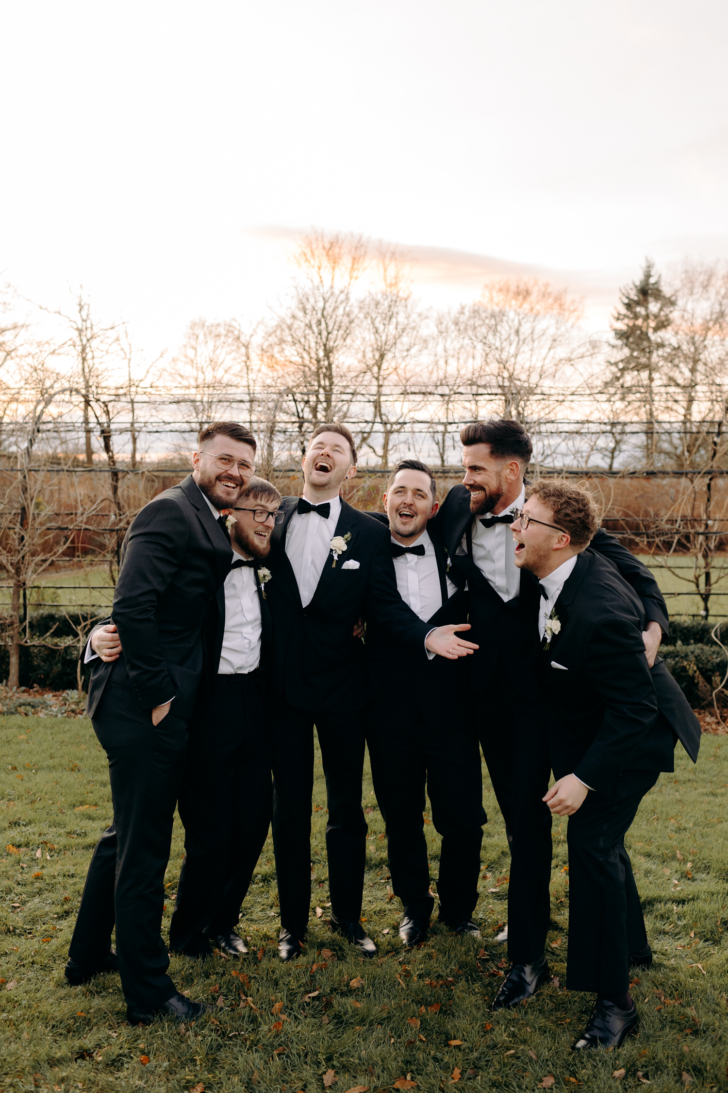 fun group photo of groom and groomsmen at winter wedding at thorpe garden