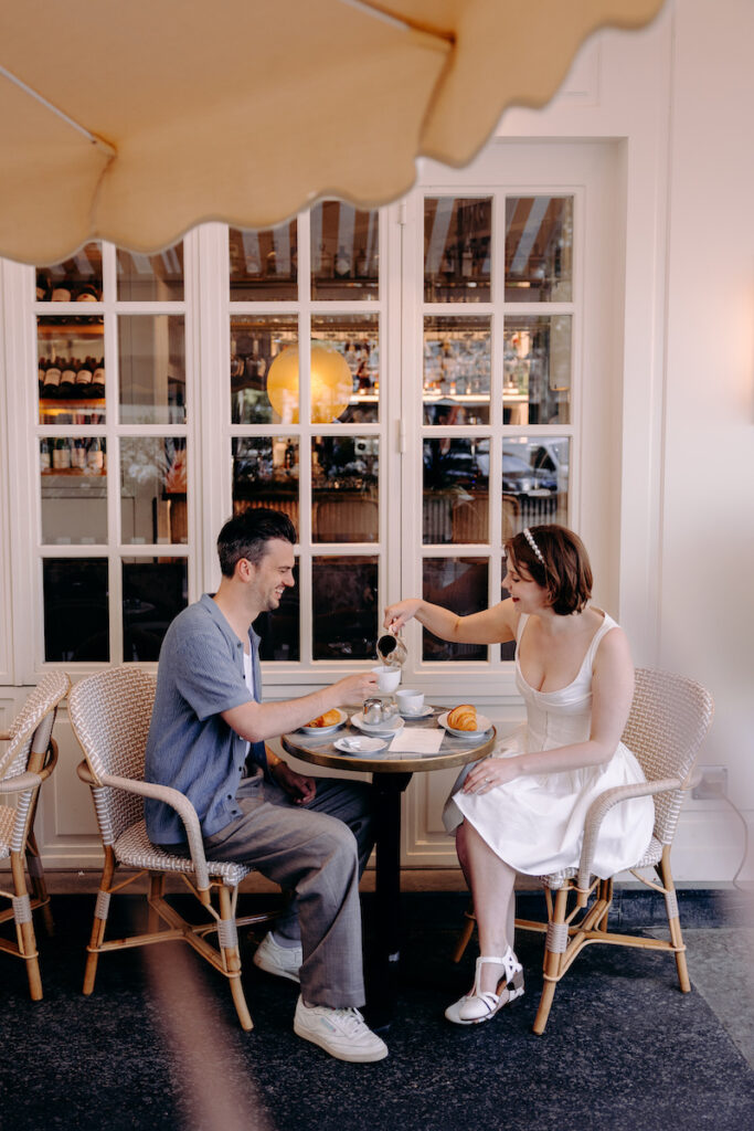 cute engagement photoshoot outside a cafe in Paris