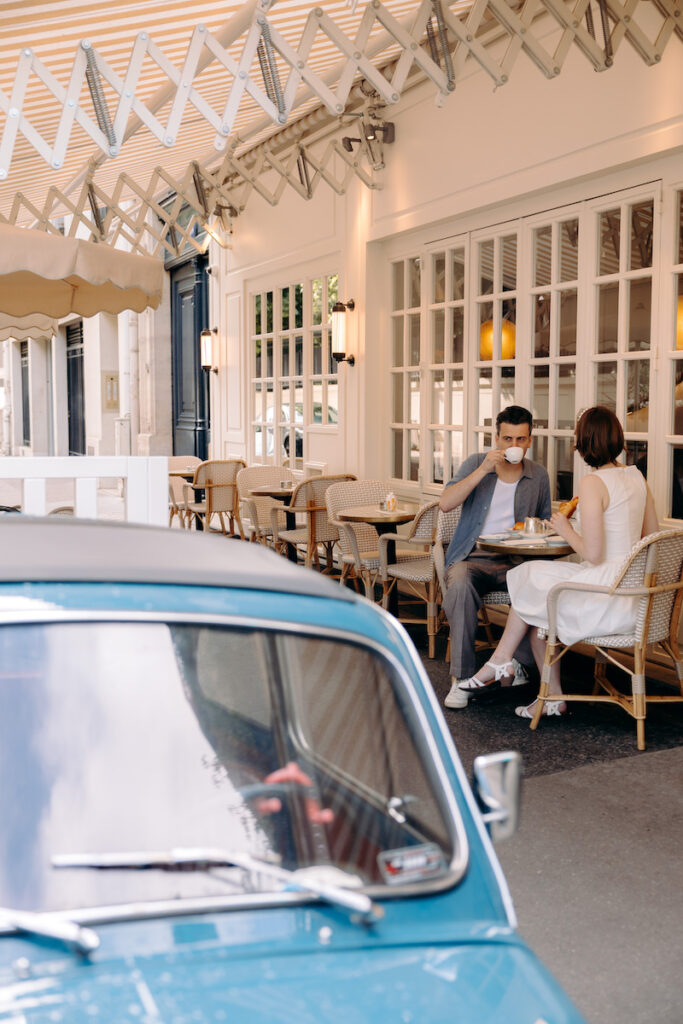 cute engagement photoshoot outside a cafe in Paris