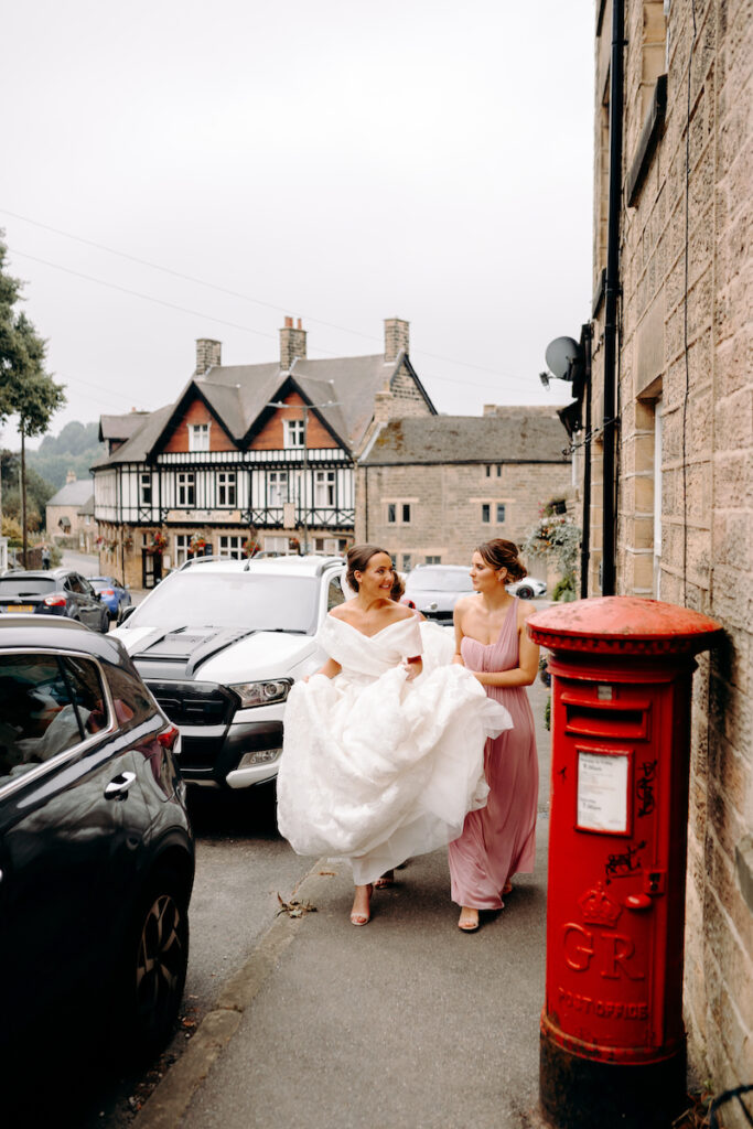 bride and bridesmaids walking through ashover to the church