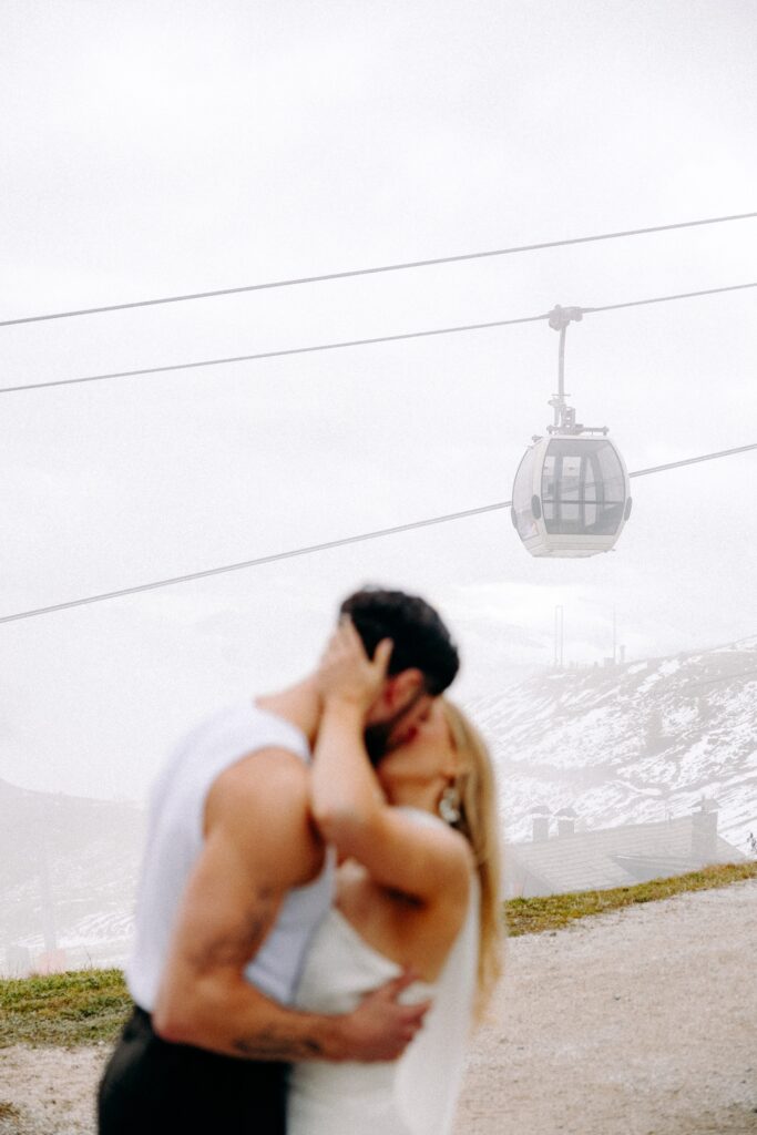 bride and groom up a mountain in the dolomites for the ski wedding