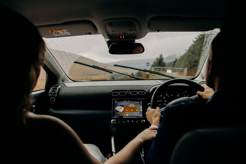 bride and groom driving between their elopement locations on isle of skye, scotland