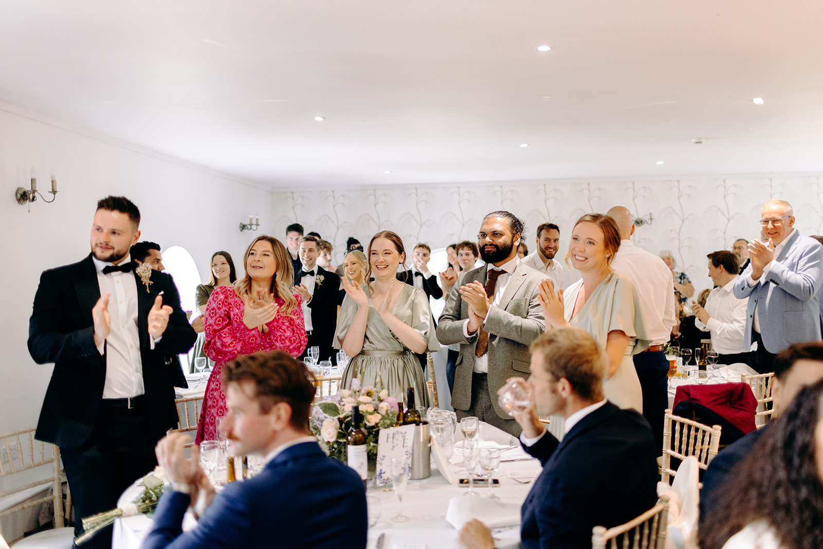 Natural photography of bride and groom walking into their wedding breakfast at Darwin Lakes.