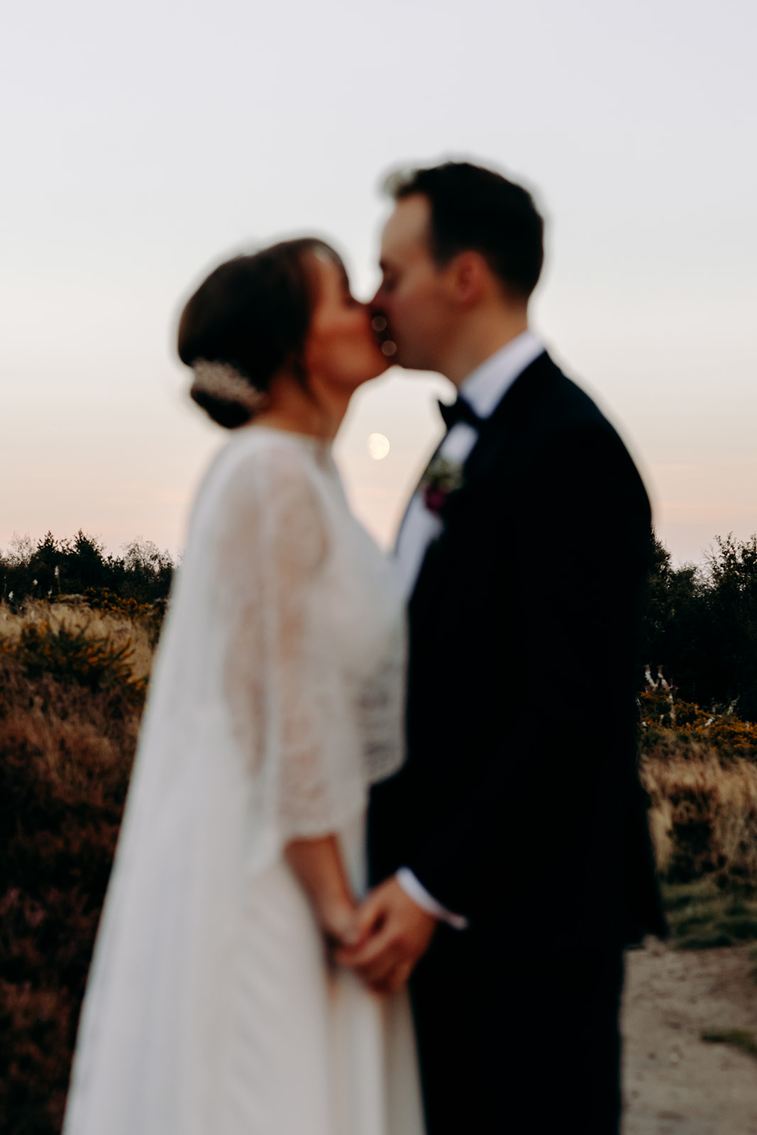 Slightly blurred romantic silhouette of the newlyweds against the sunset – creative wedding photography at Darwin Lakes.