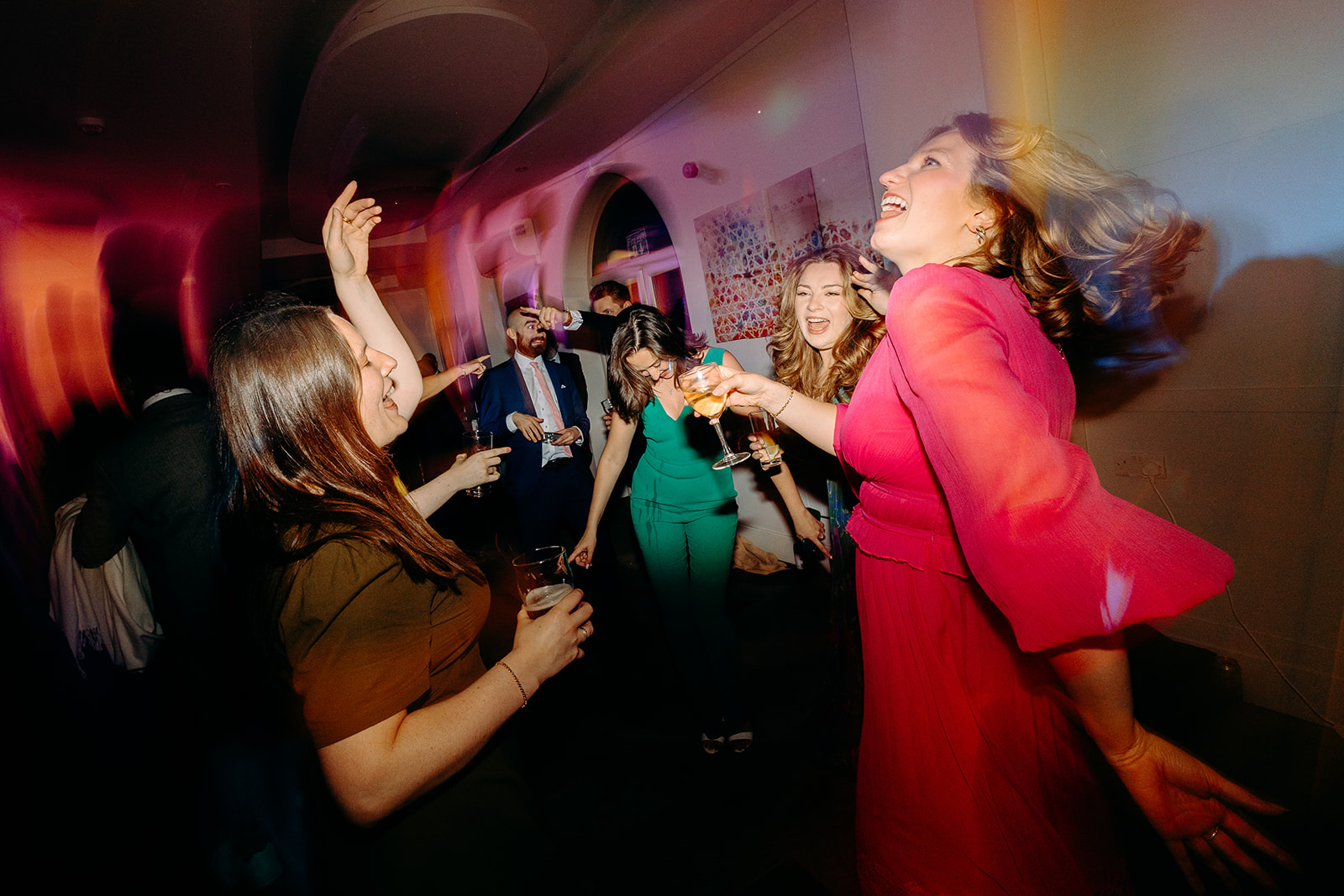 The bride and her friends jumping and singing to music — a lively moment from a Peak District wedding.