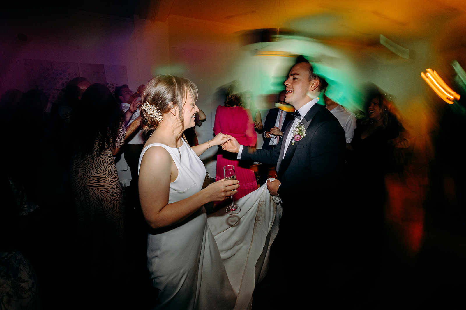 Bride and groom dancing with friends in the middle of a lively reception at Darwin Lakes.