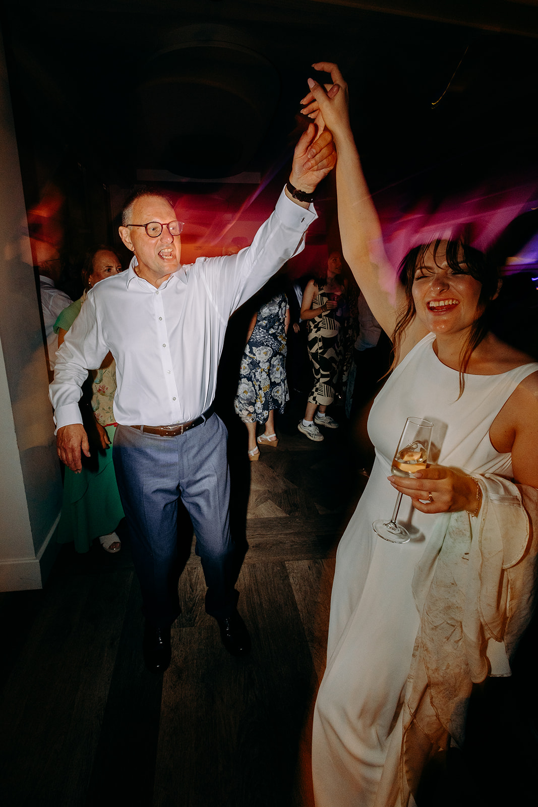Father of the bride twirling the bride on the dance floor, captured with dynamic motion blur.