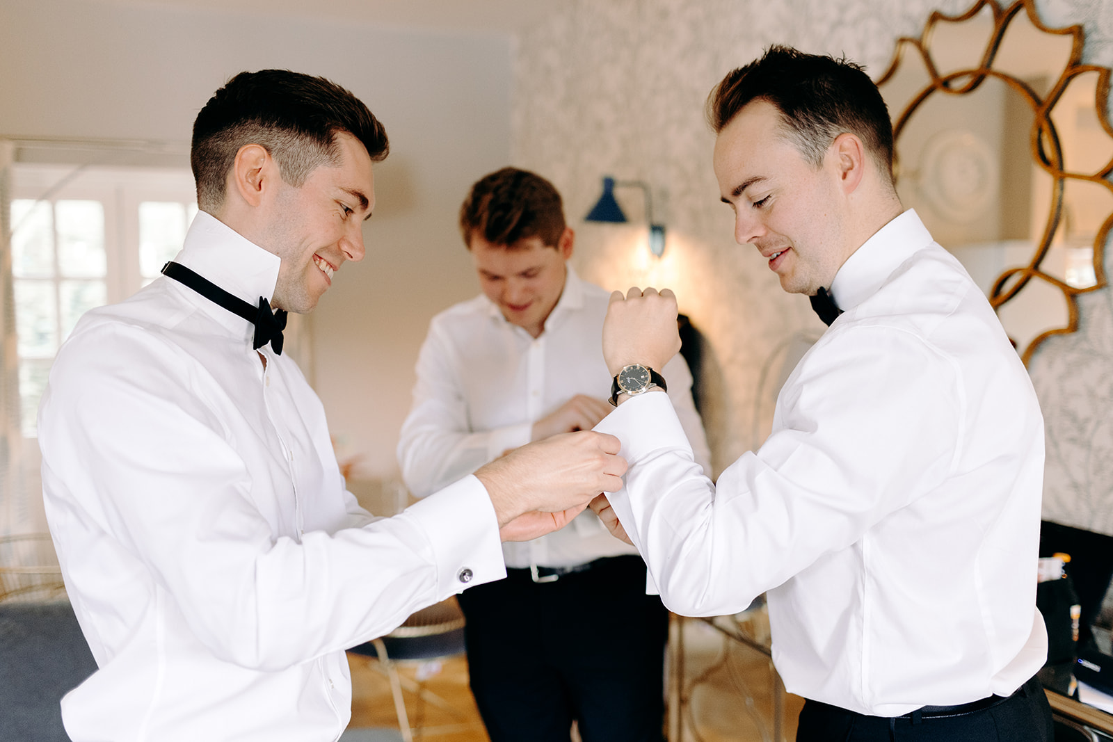 Fun moment between groomsmen getting ready, a classic example of candid wedding photography in Derbyshire.