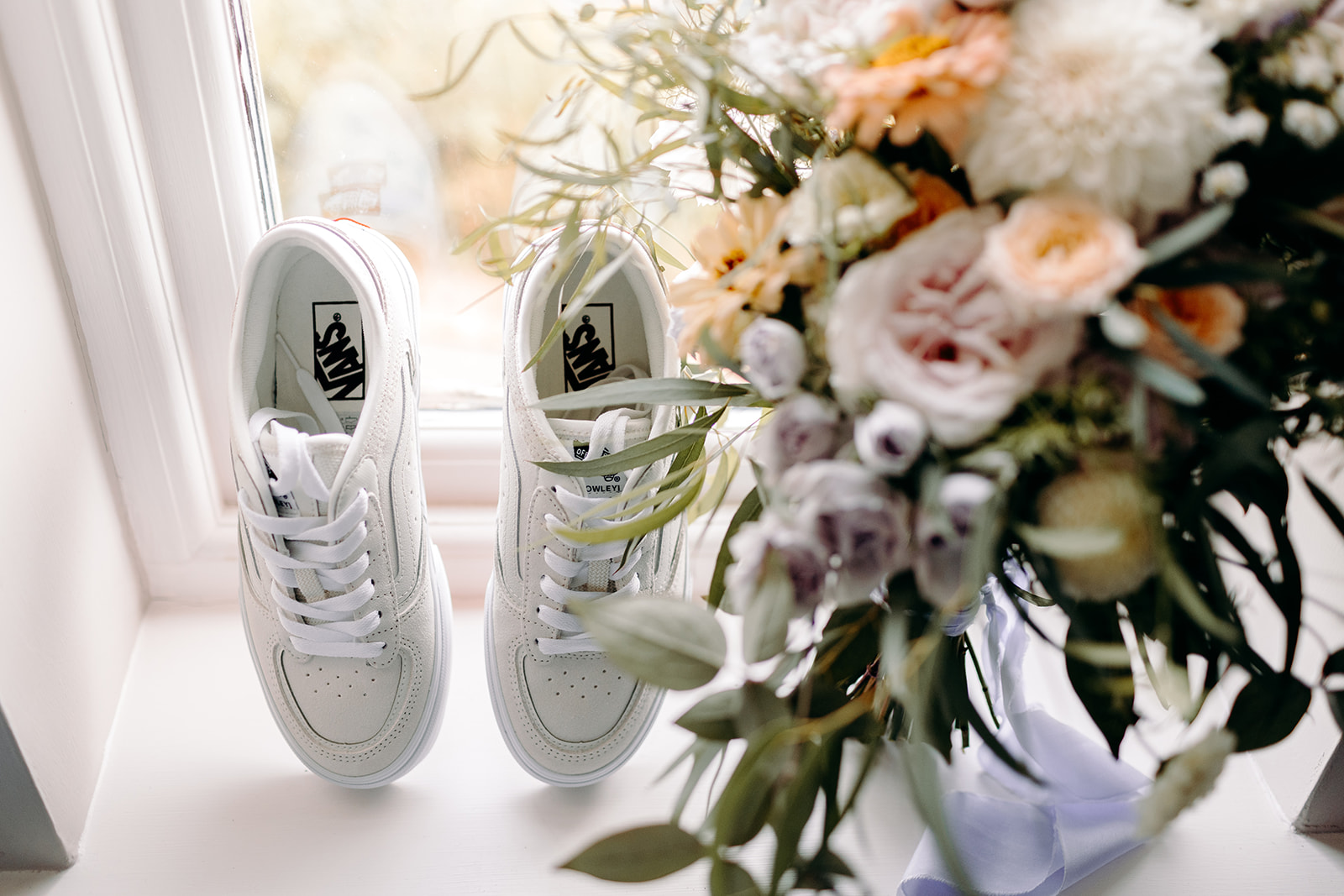 The bride's wedding trainers with her natural, wild wedding flowers.
