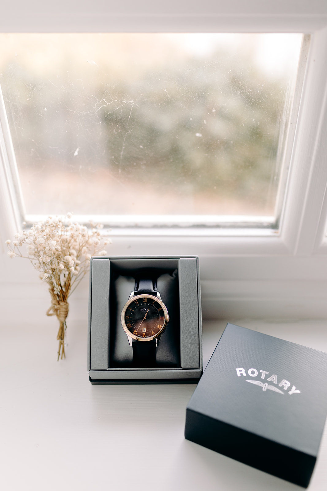 Flat lay of groom’s Rotary wedding day watch with an editorial photography vibe – soft light and thoughtful styling.