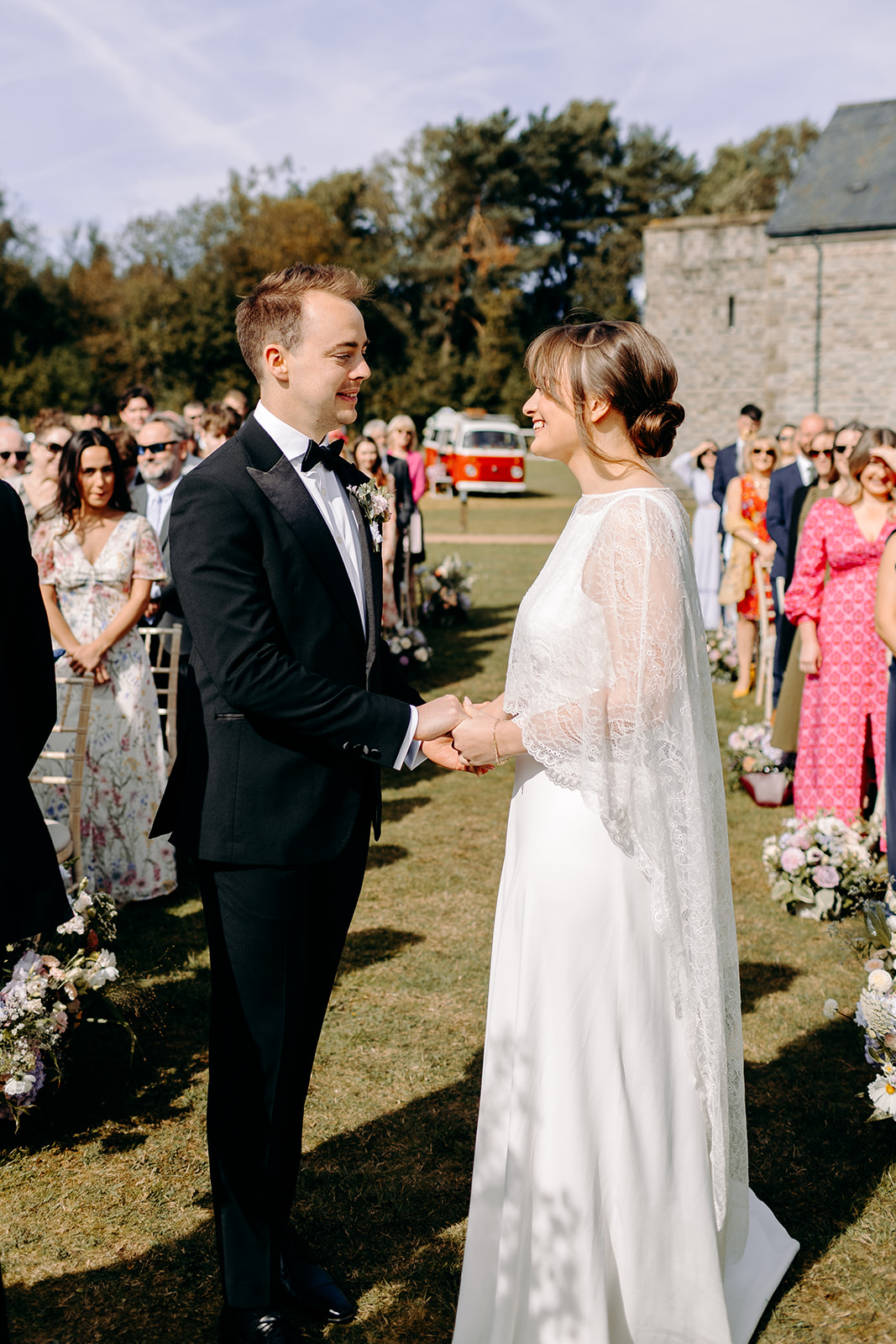 Exchange of vows under wooden arch, editorial wedding photography with heartfelt storytelling.