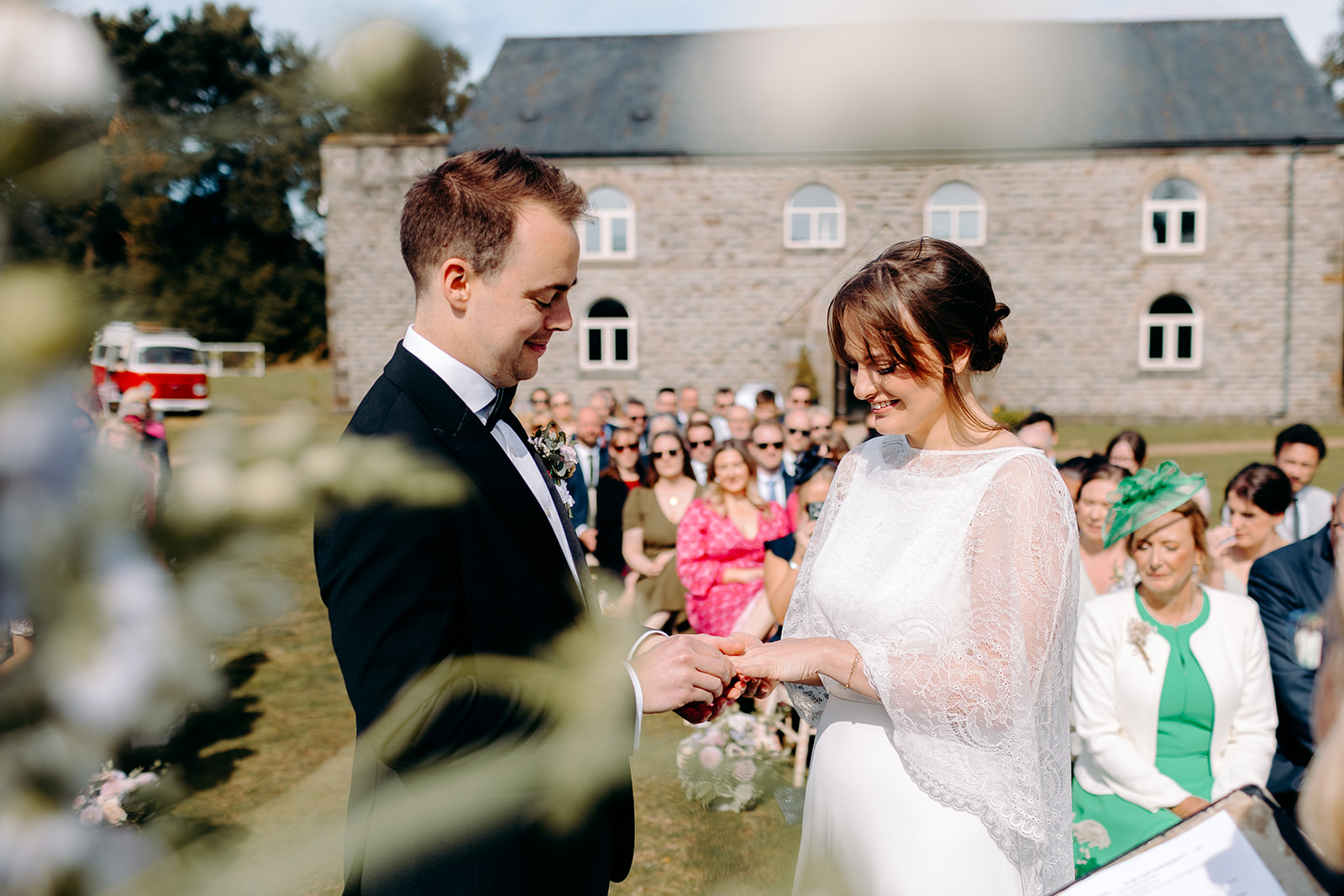 Bride and groom exchanging wedding rings during their outdoor, Peak District wedding ceremony.
