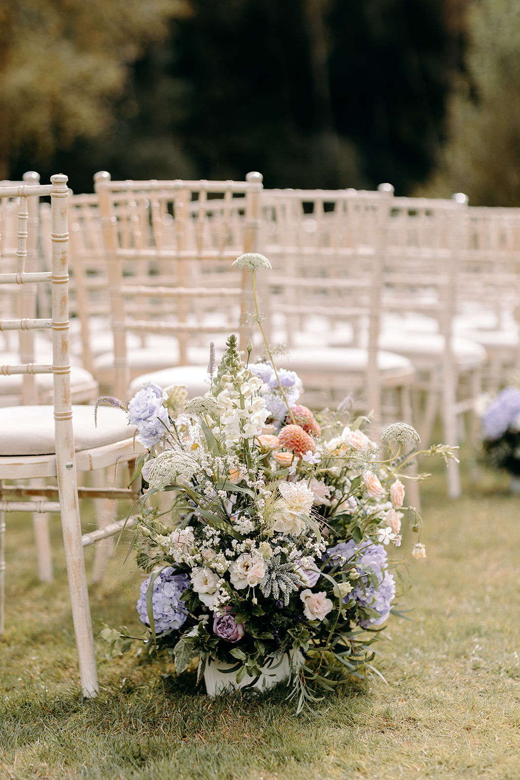 Lakeside wedding ceremony setup at Darwin Lakes holiday village, with wild purple flowers.