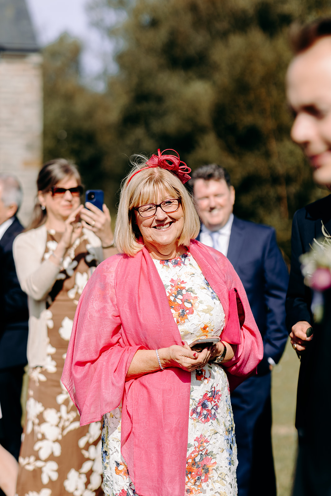 Guest at a wedding at Darwin Lakes smiling at the bride and groom, intimate Peak District wedding moment.