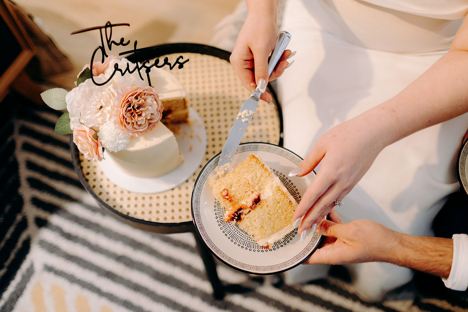 A couple who have just eloped to the Isle of Skye, cutting their tiny wedding cake in their cosy accommodation