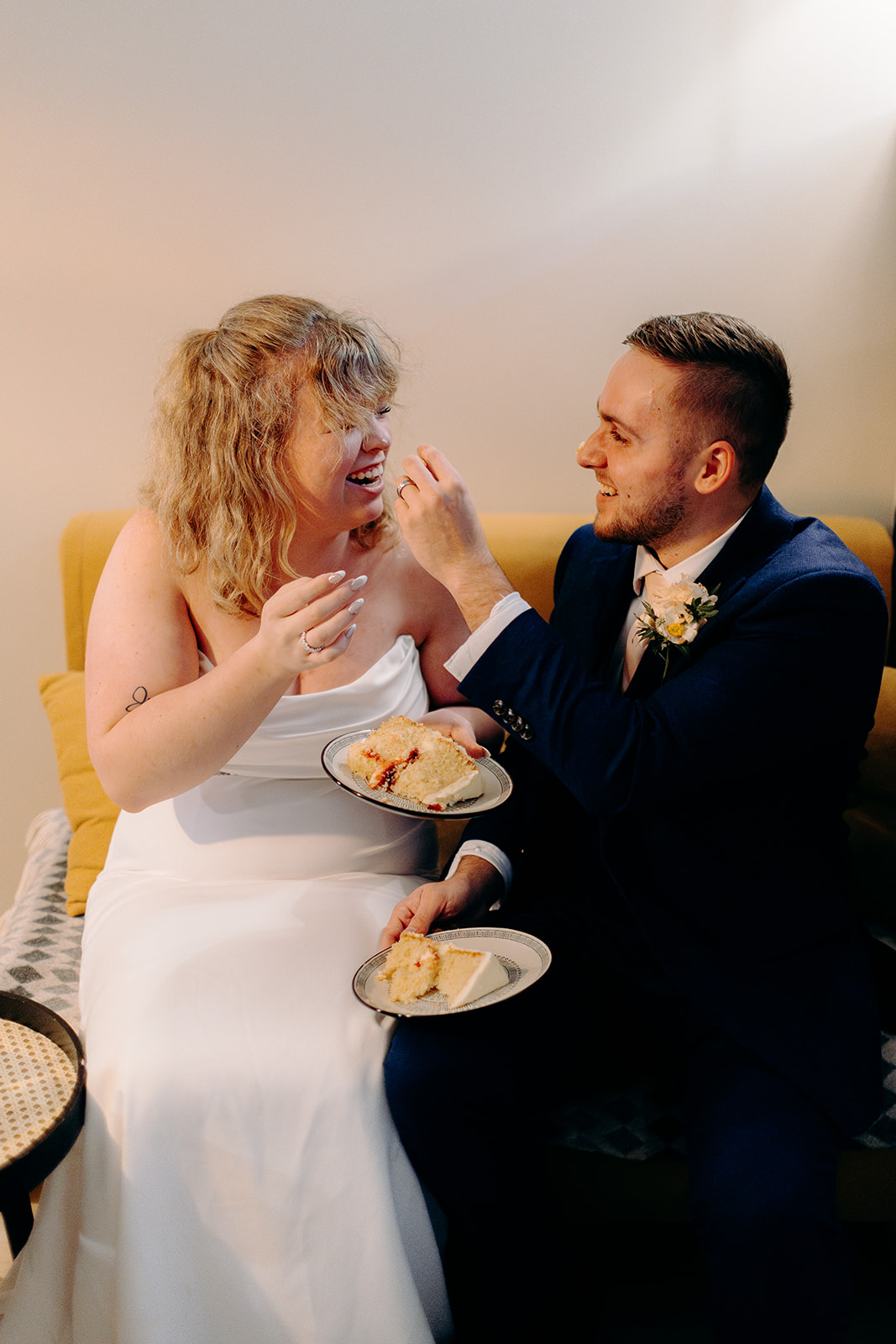 Groom feeding bride their tiny wedding cake after their ceremony for just the two of them in the Scottish Highlands