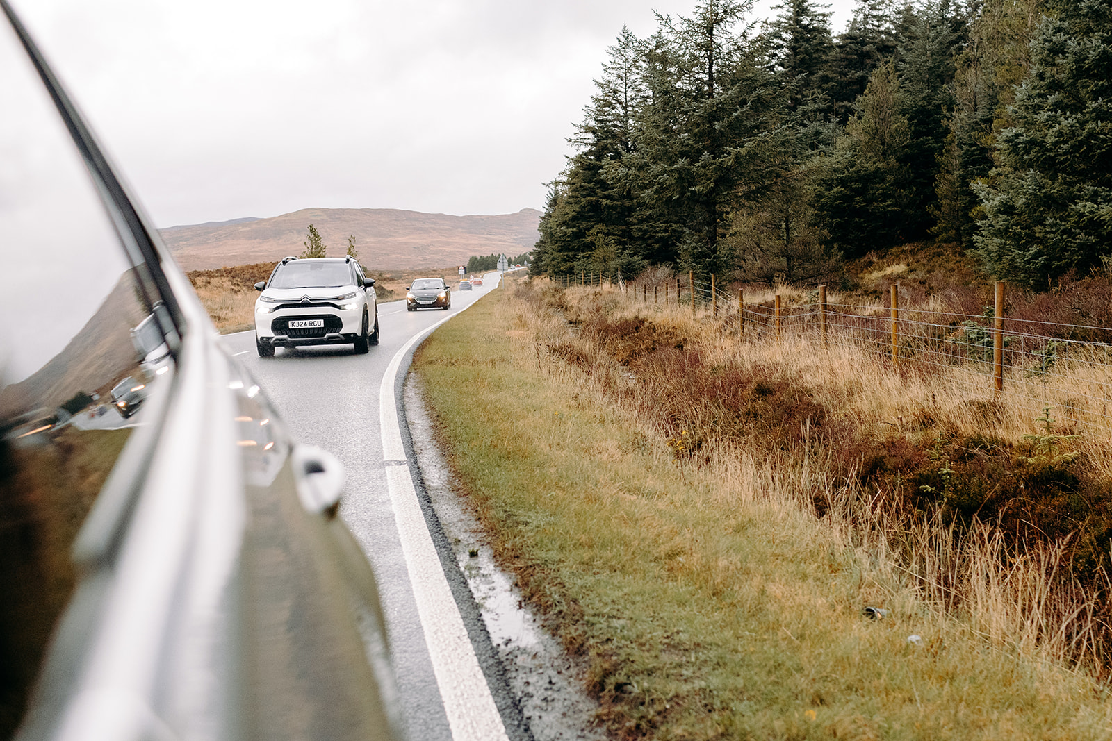 Driving through winding Highland roads en route to a Fairy Pools elopement ceremony on the Isle of Skye