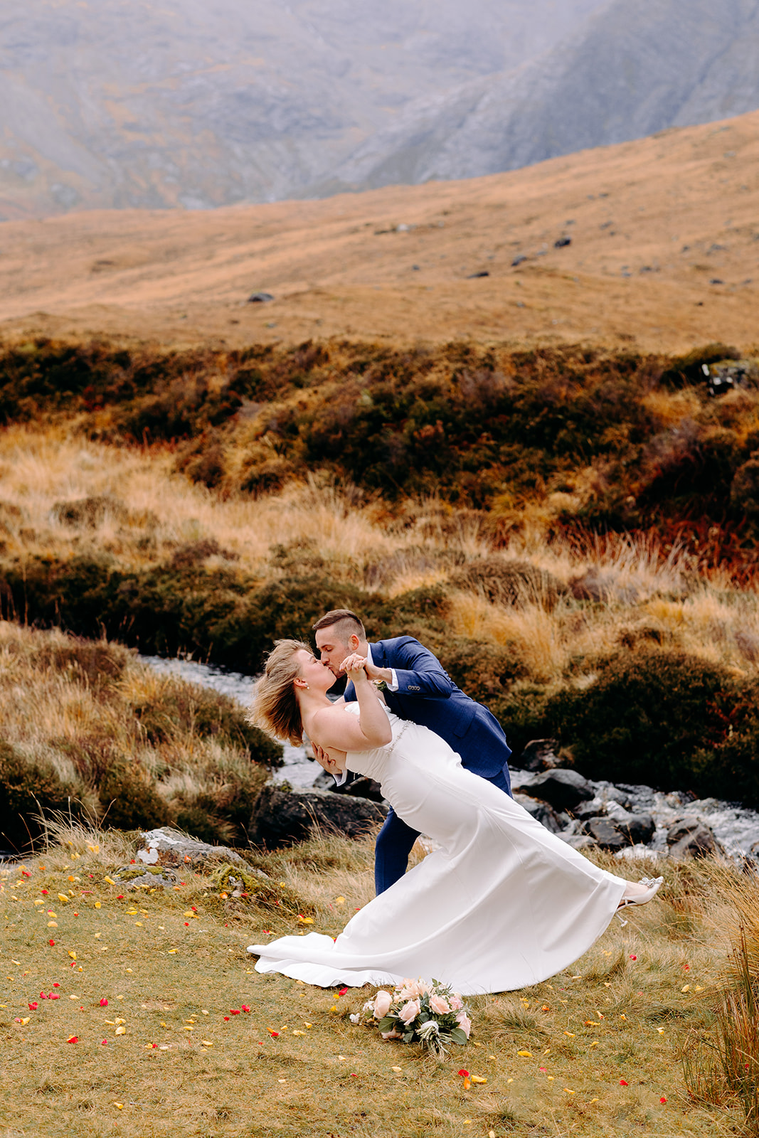 Groom twirling bride in the moorlands during their Scottish elopement
