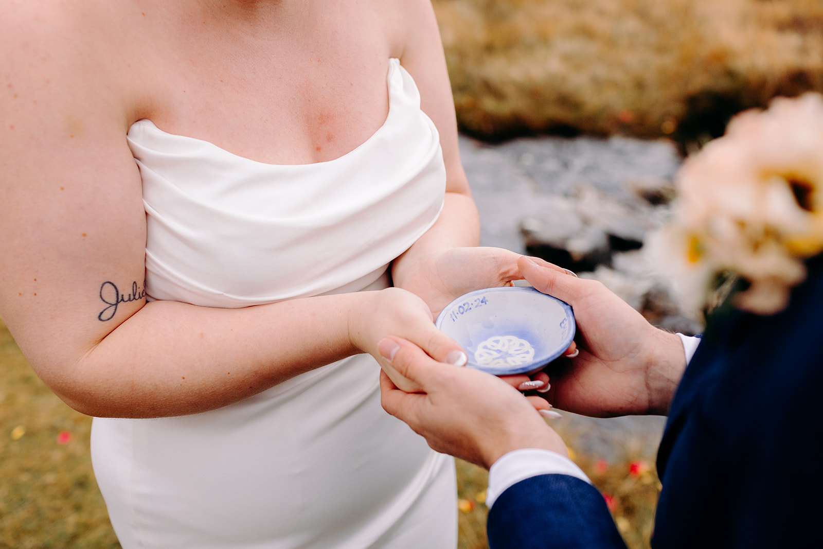 Bride holding a handmade and personalised quiach with ceremony details in Cairngorms