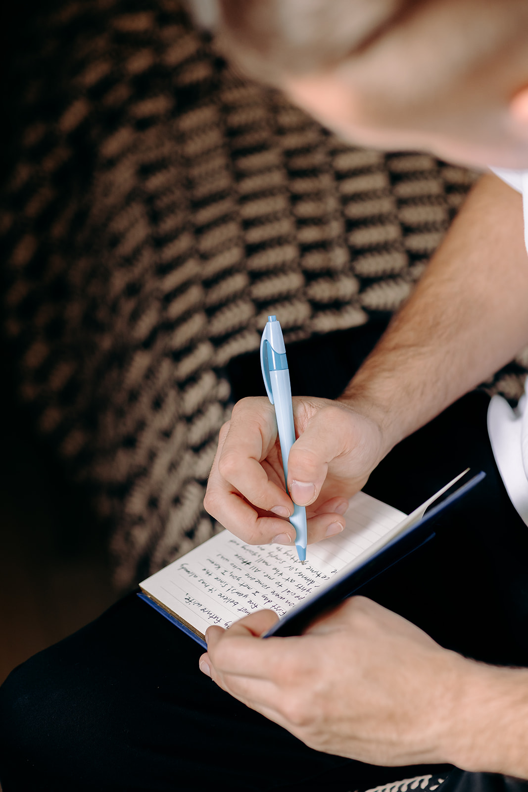 Close-up of groom writing his vows on the morning of his Scotland elopement.
