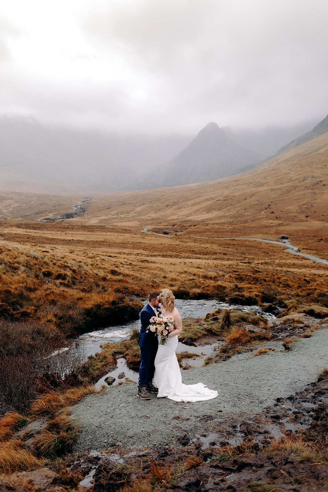 Bride walking toward her partner on a misty trail in the Isle of Skye – one of my favourite Scottish elopement spots.