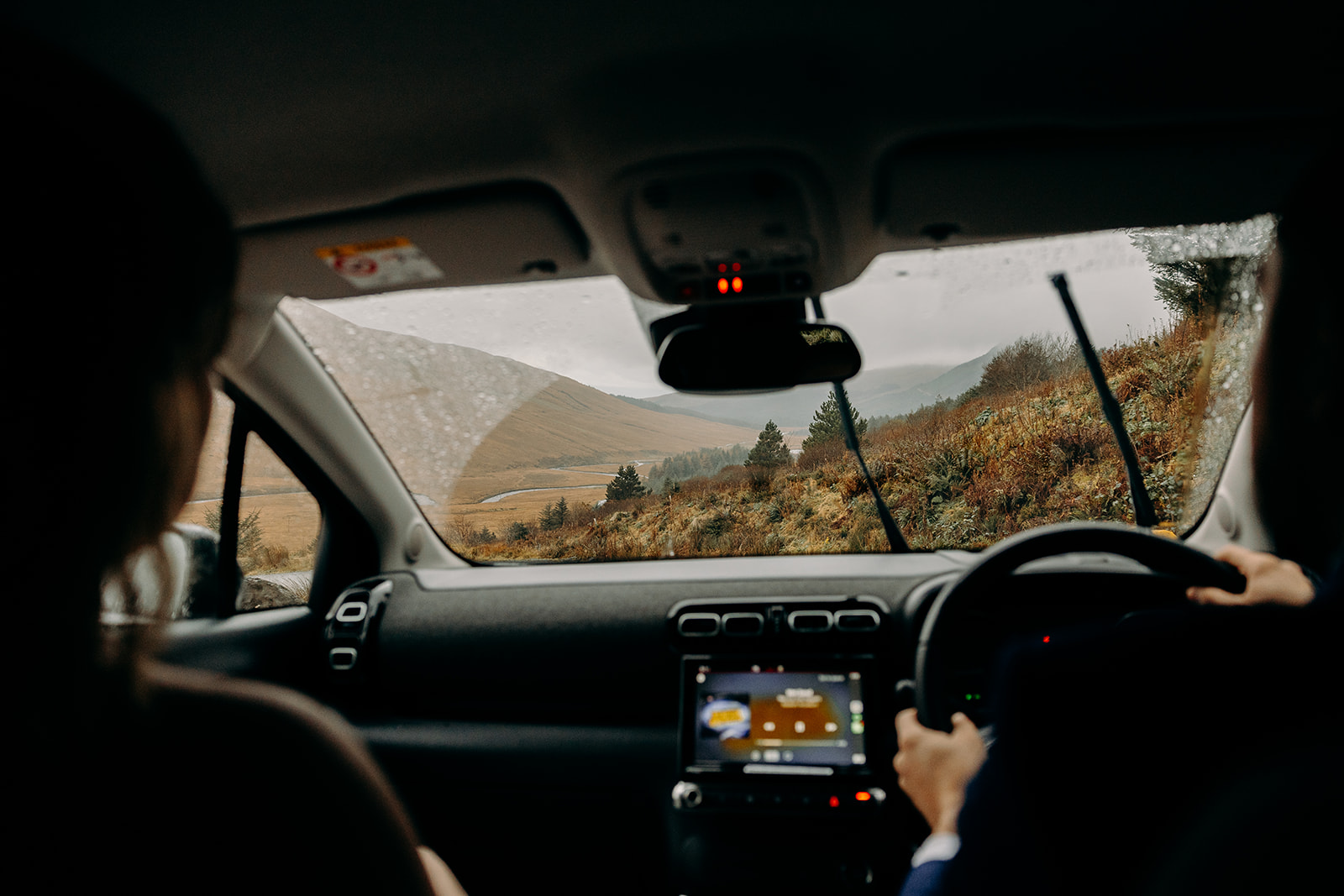 A little behind-the-scenes moment from the car, on the road to their Isle of Skye elopement adventure.