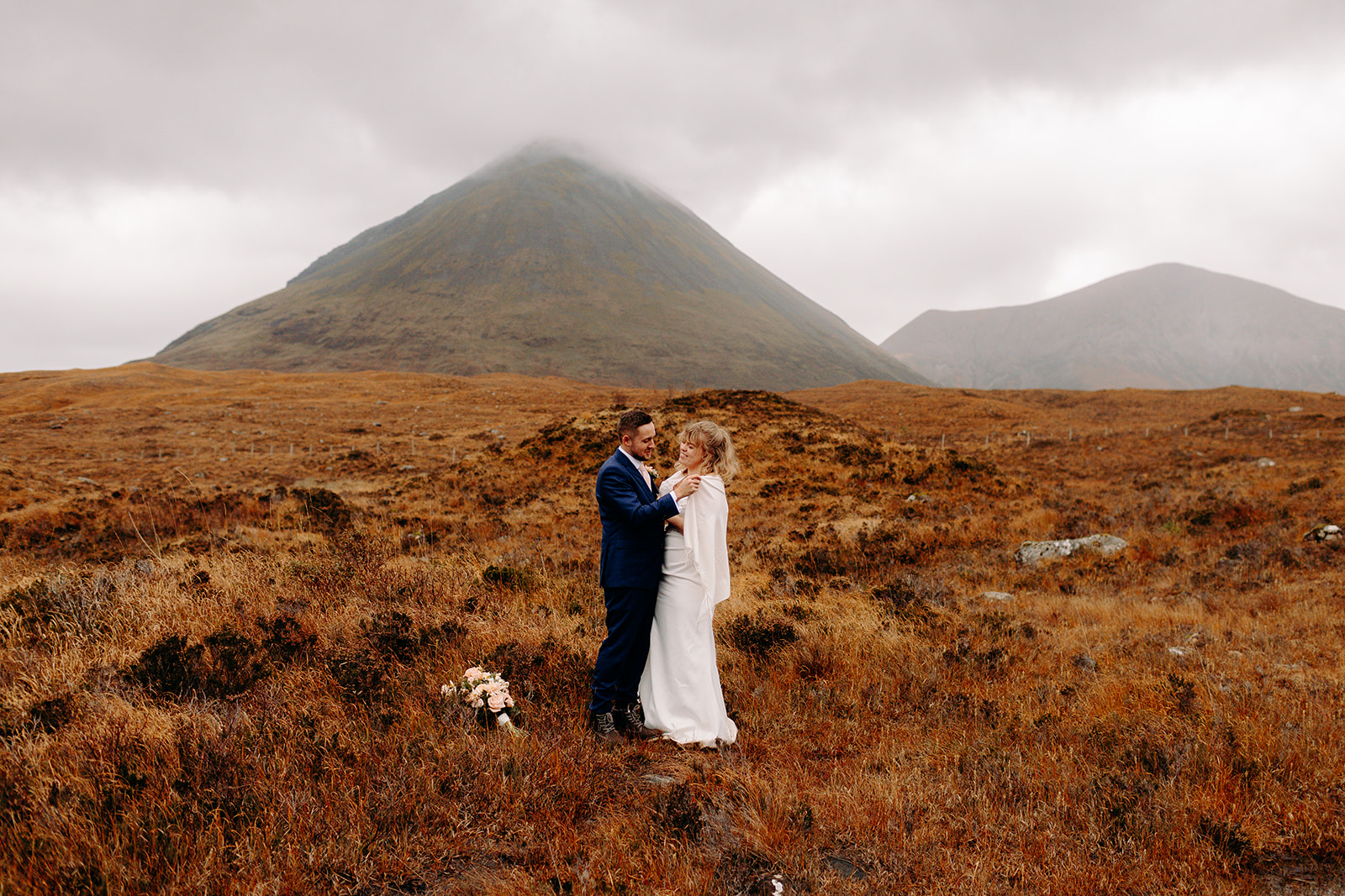Holding hands and taking it all in — a quiet moment together during their elopement in the Scottish Highlands.