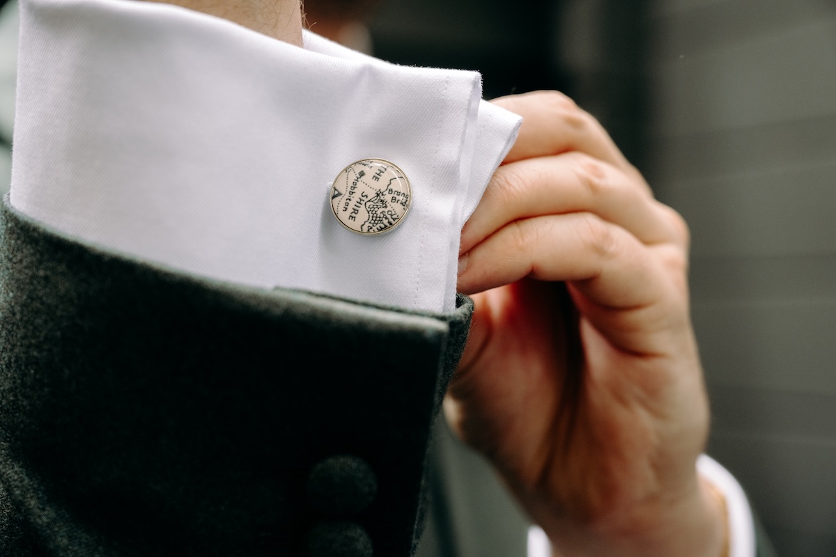 Detail of cufflink with Lord of the Rings map – stylish groom detail for a themed Marleybrook House wedding.