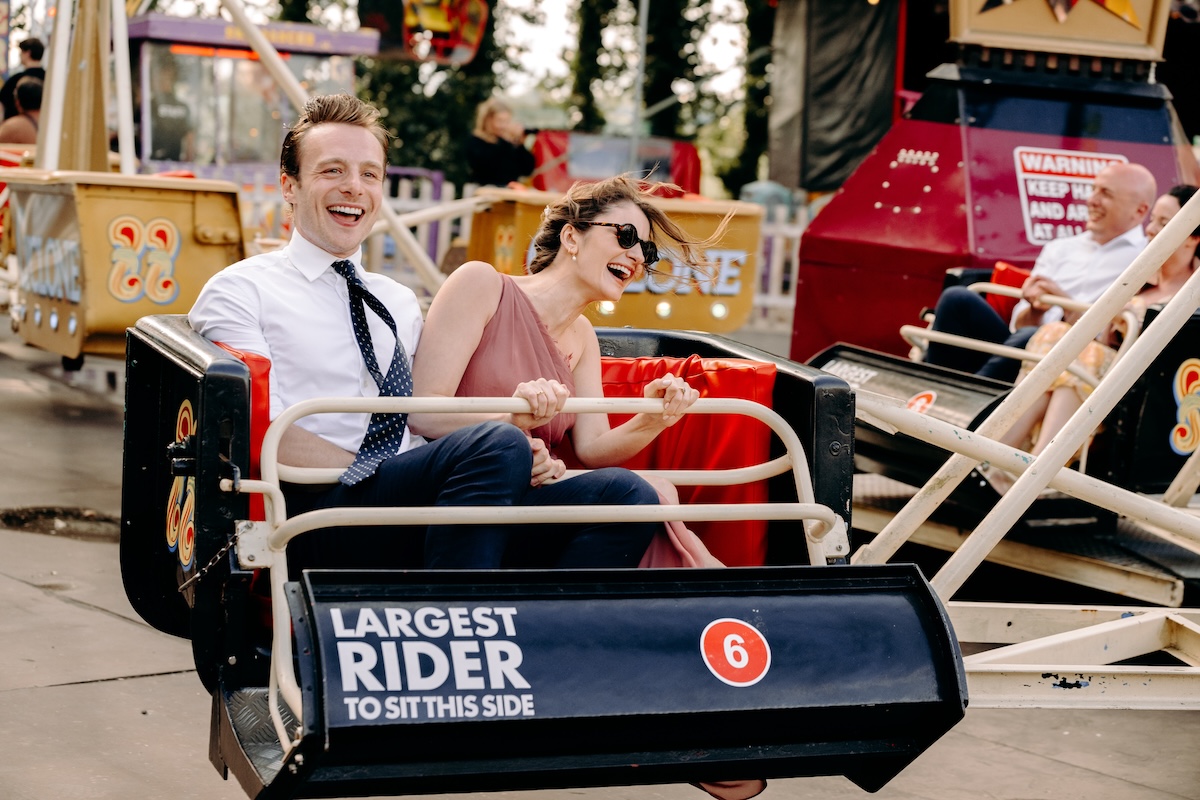 Wedding guests having fun on a ride at a UK wedding venue with a fairground