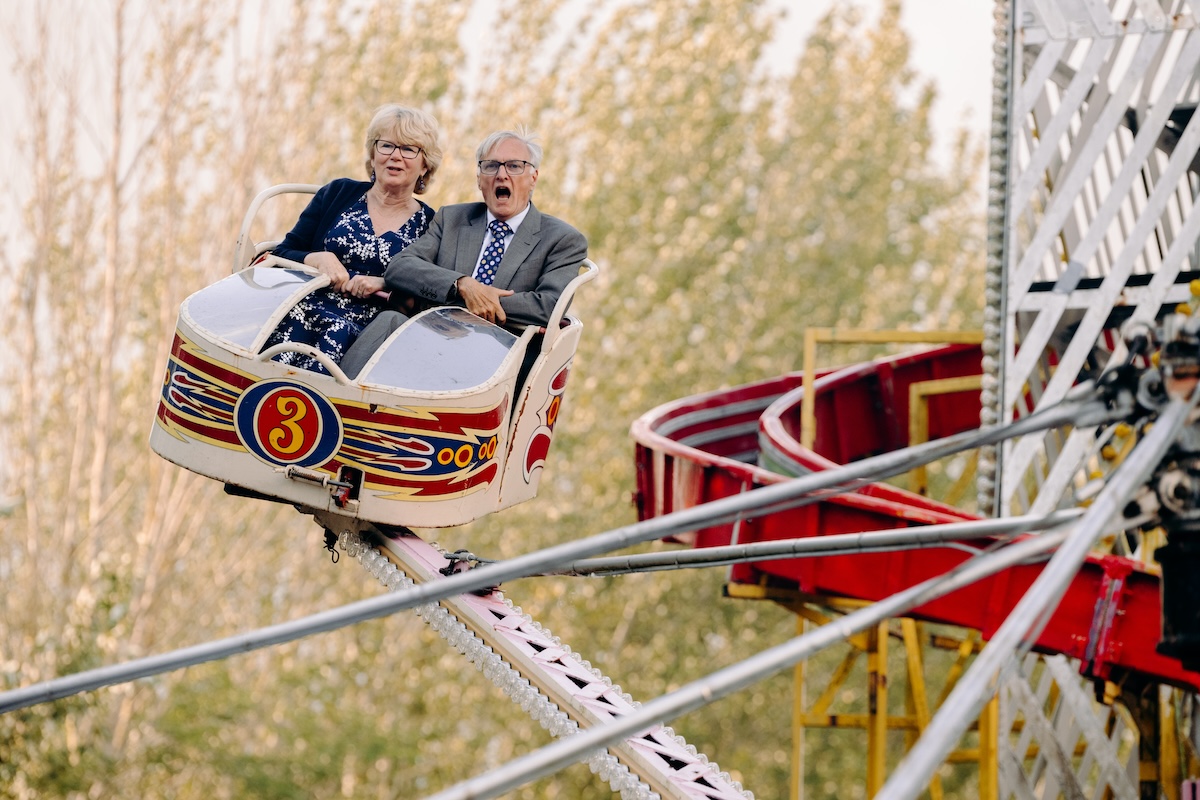 Wedding guests having fun on a ride at a UK wedding venue with a fairground