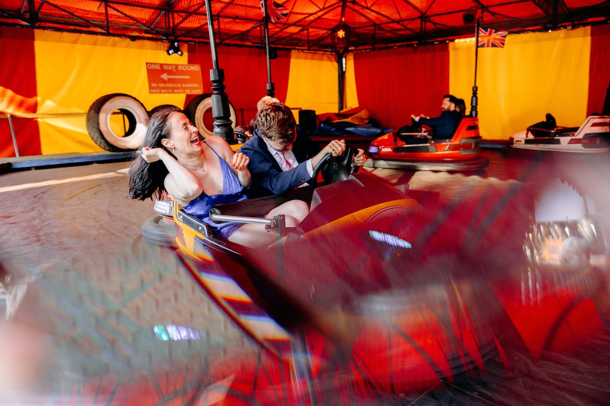 Fun photo of wedding guests on the dodgems at Marleybrook House - fun wedding photography
