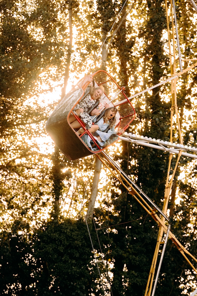 Guests having fun on a ride at a UK wedding venue with a fairground