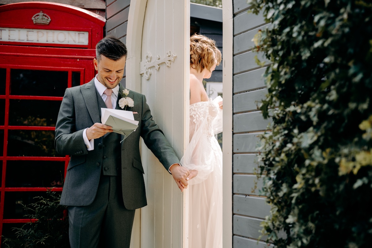 Couple holding hands around a corner, not seeing each other – intimate pre-ceremony moment at Marleybrook House.