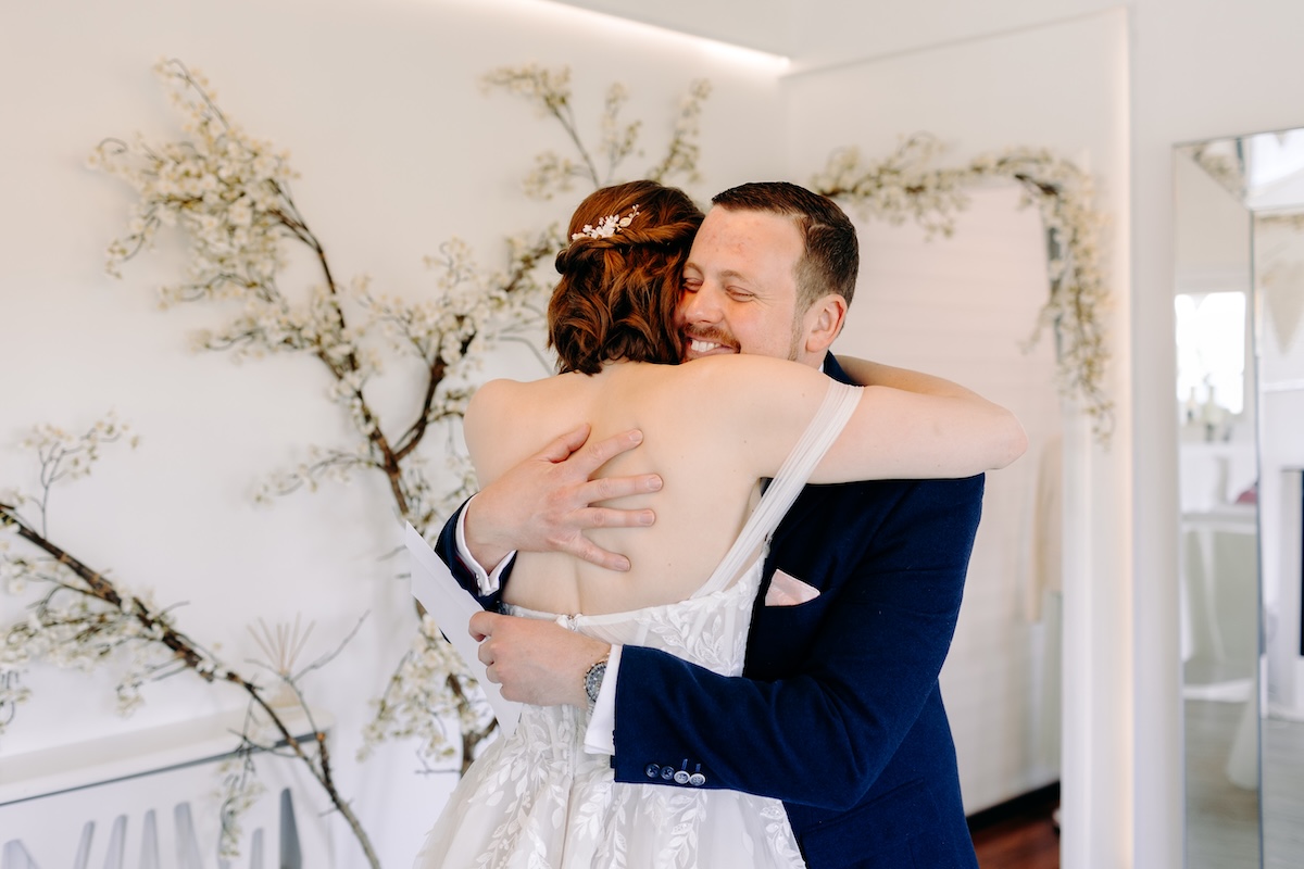 Bride and her brother embrace in a huge after their first look – natural wedding photography at Marleybrook House.
