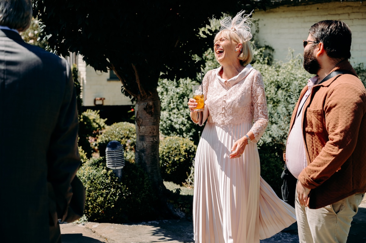 Candid photo of guest laughing – joyful, relaxed moments at a Marleybrook House wedding.