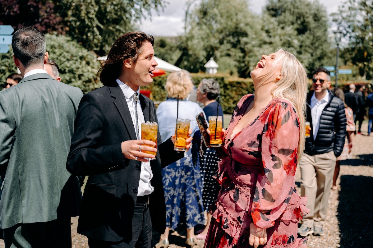 Candid photo of guests laughing – joyful, relaxed moments at a Marleybrook House wedding.