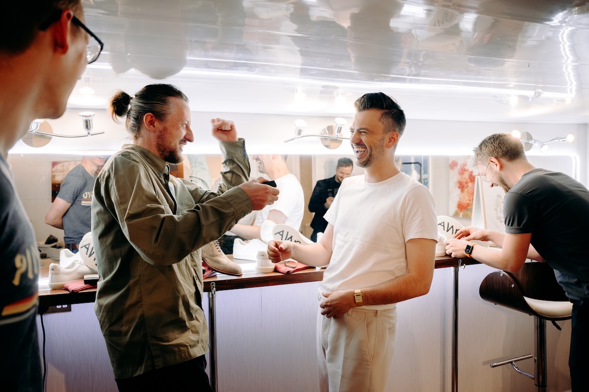 Candid moment of the groom joking with his friends during prep – relaxed, fun wedding photography at Marleybrook House.