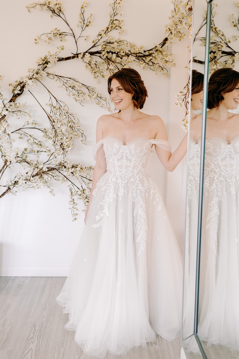 Bride standing gracefully in her off-the-shoulder gown – timeless bridal portrait at Marleybrook House wedding.