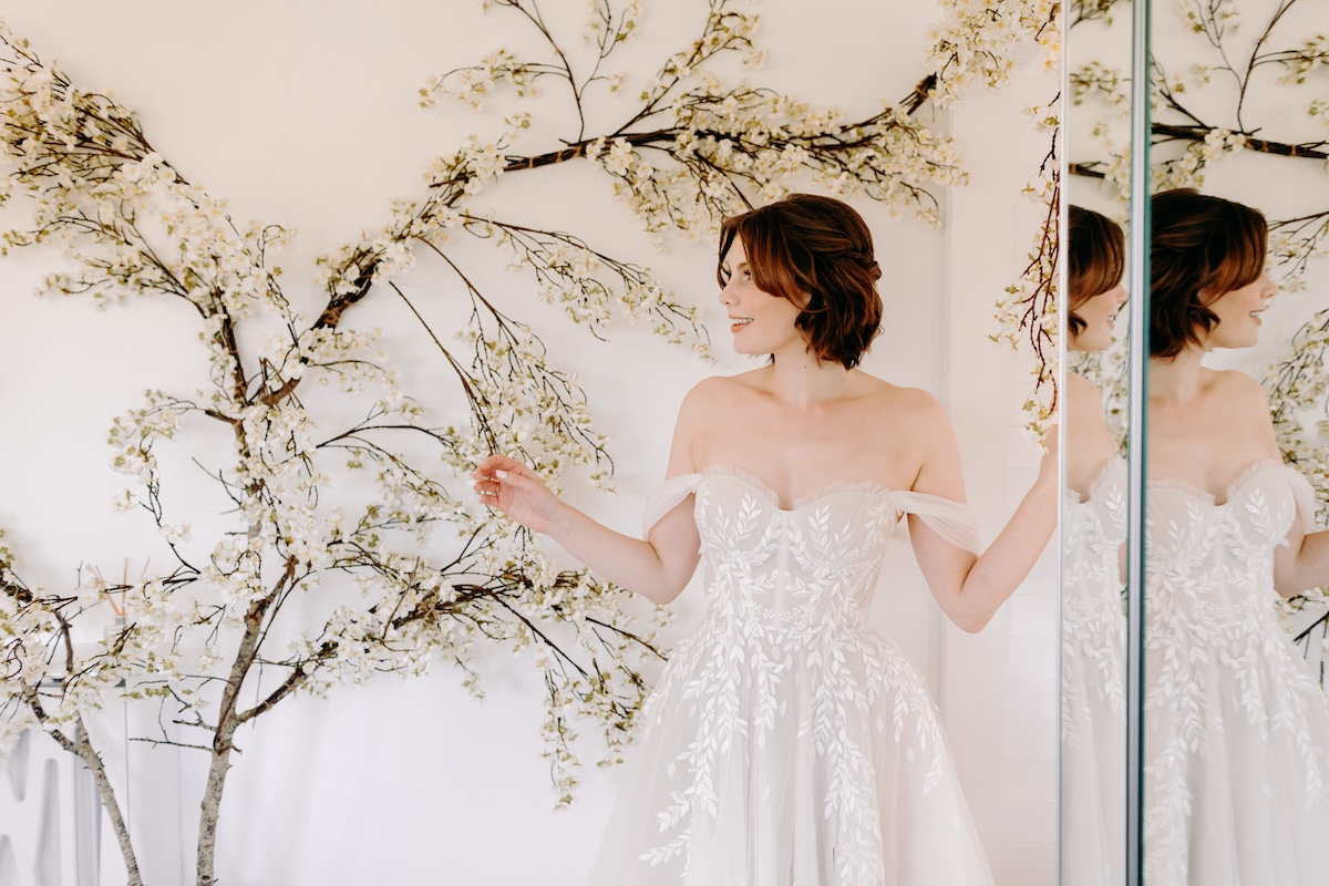Bride looking out the window before heading to the ceremony – quiet moment before outdoor vows at Marleybrook House.