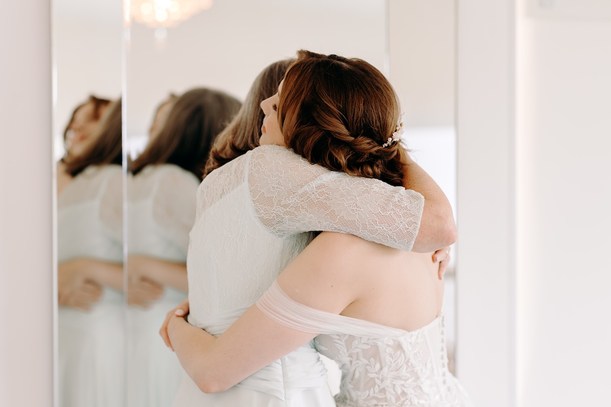 Bride hugging her mum during emotional pre-ceremony moment – captured naturally at Marleybrook House.