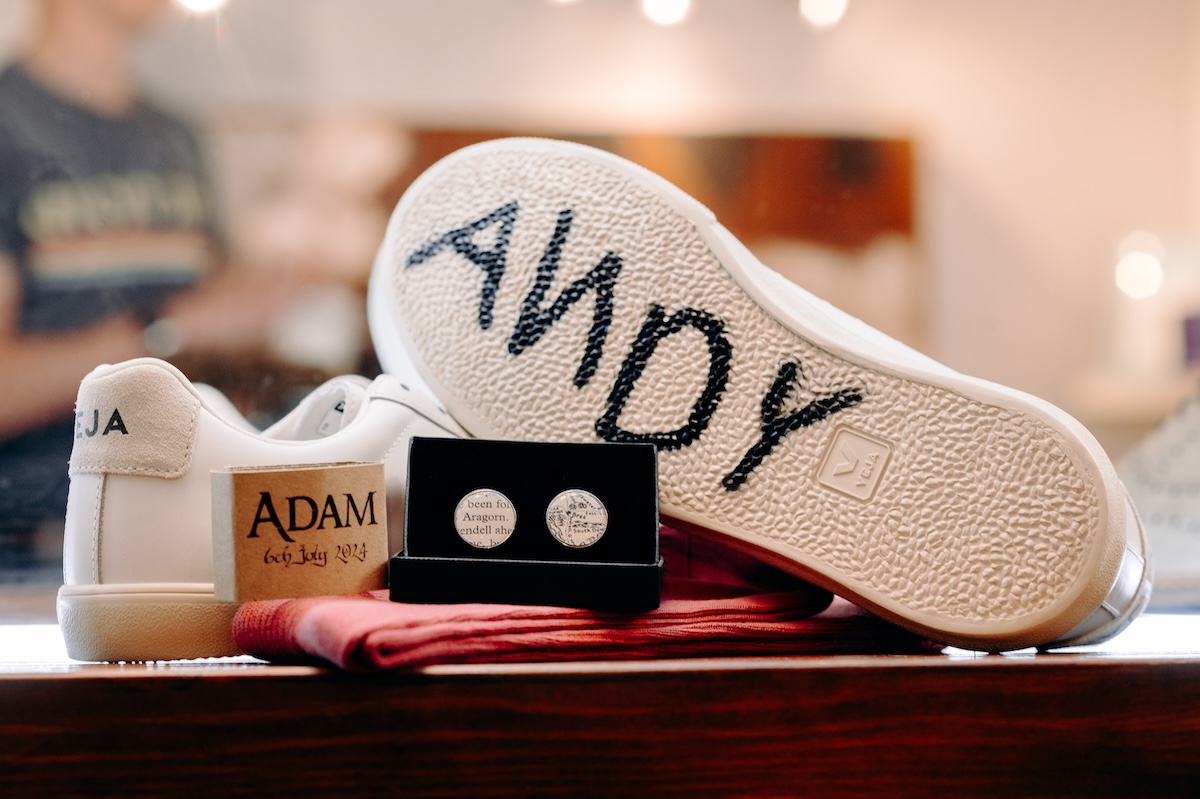 Close-up of custom wedding Converse with "ANDY" design – subtle Disney theme at a Marleybrook House wedding.