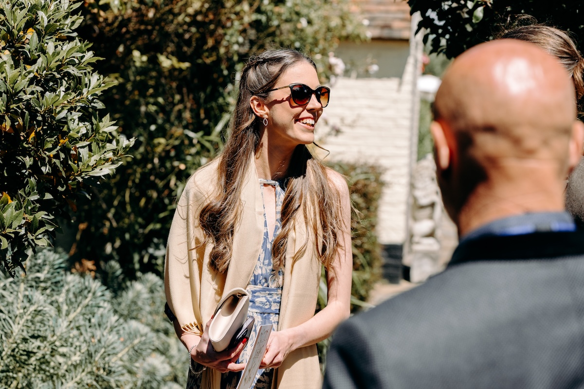 Guests enjoying drinks in the garden before the ceremony – relaxed outdoor vibe at Marleybrook House wedding.