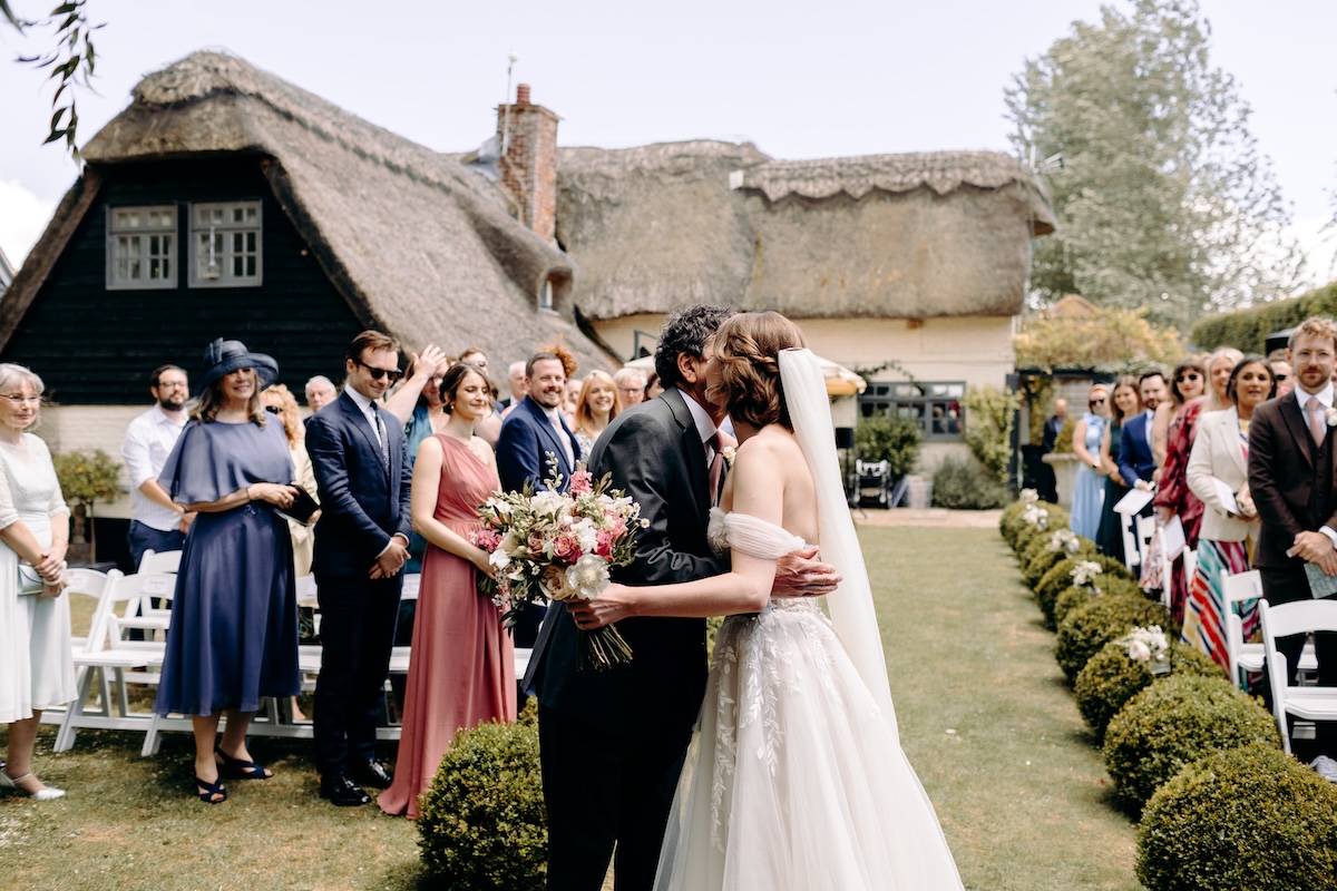 Bride hugging her dad once she reaches the top of the aisle – natural wedding photography at Marleybrook House.