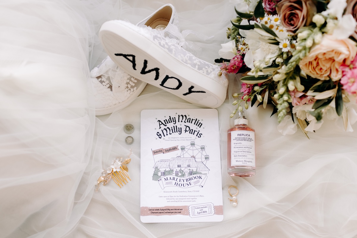 Flat lay of the wedding invitation and floral details – elegant Disney-inspired touches for a Marleybrook House wedding.