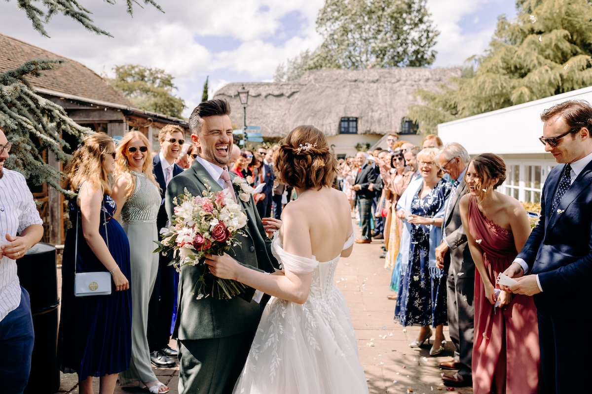 Candid confetti moment as the couple celebrate their outdoor ceremony with relaxed guests.