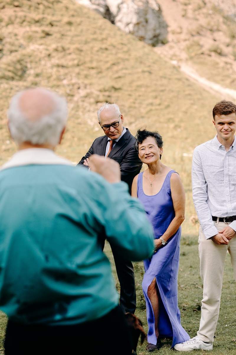 Bride and guests sharing a moment before the ceremony in the dramatic Peak District landscape.
