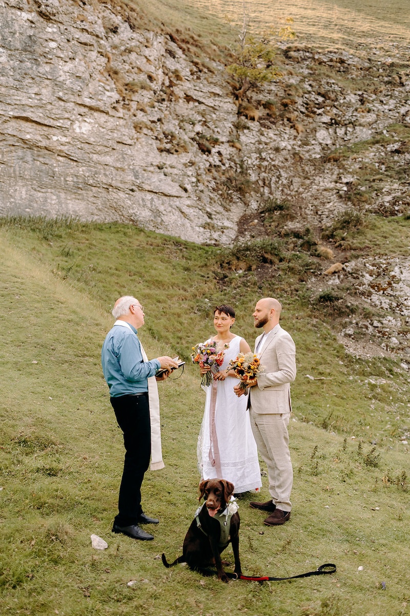 Celebrant speaking with the couple before the ceremony in a secluded Peak District valley.
