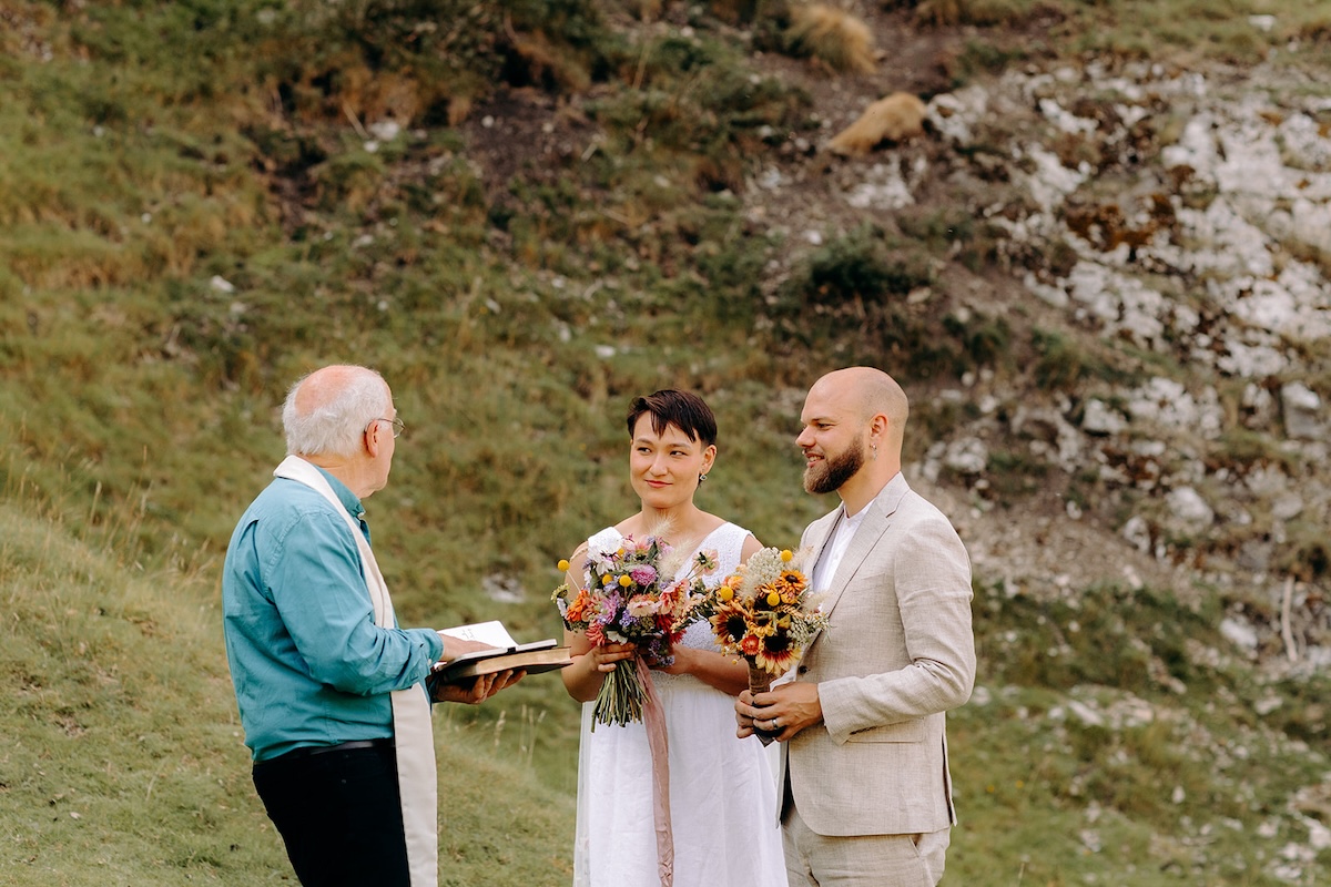 Couple listening to their celebrant during their outdoor Peak District elopement.
